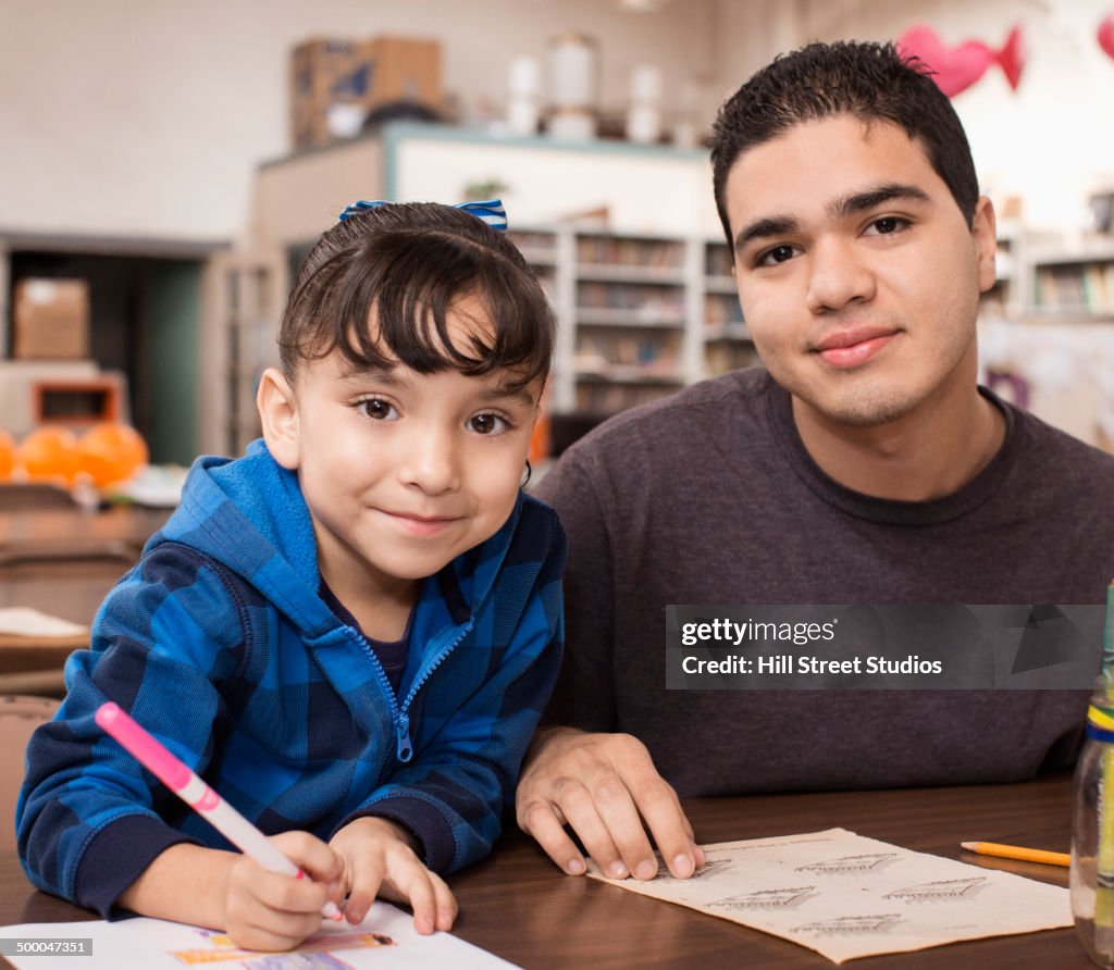Student and teacher working in classroom