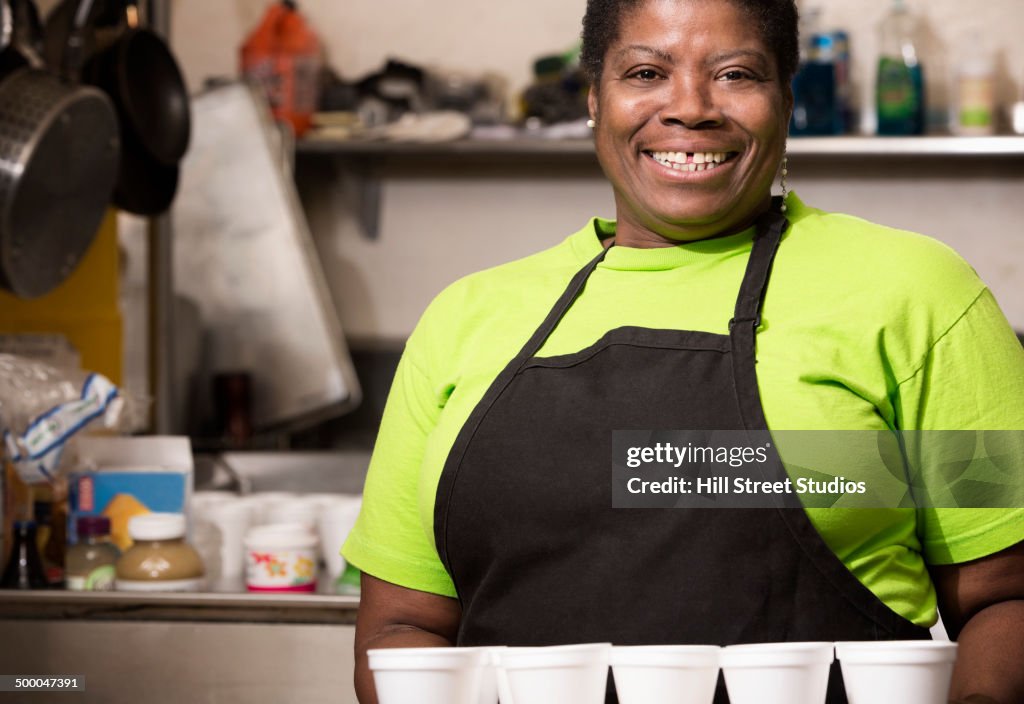 Mixed race chef smiling in school cafeteria kitchen