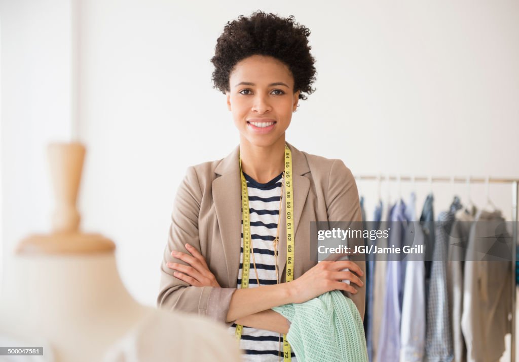 Black dressmaker smiling in studio