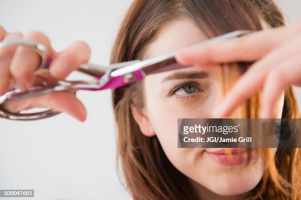 woman trimming her bangs - bad haircut photos et images de collection