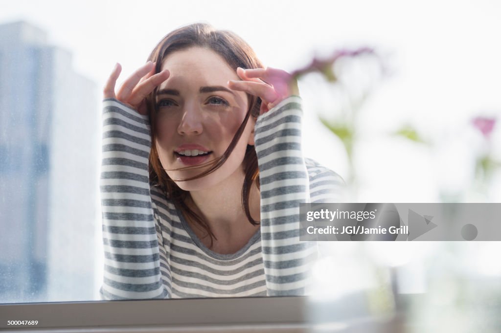 Woman peering in through window