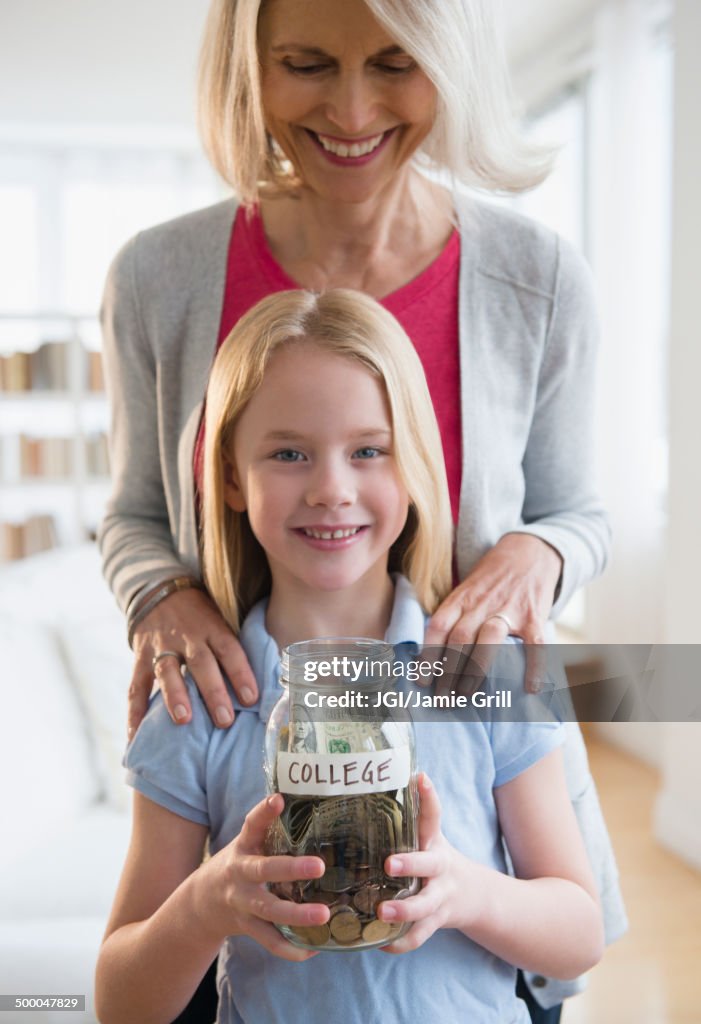 Senior Caucasian woman and granddaughter saving for college