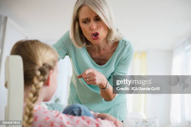 senior caucasian woman scolding granddaughter - ilska bildbanksfoton och bilder