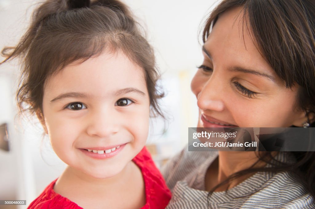 Hispanic mother and daughter hugging