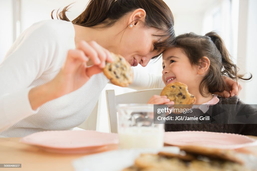 Hispanic mother and daughter eating together