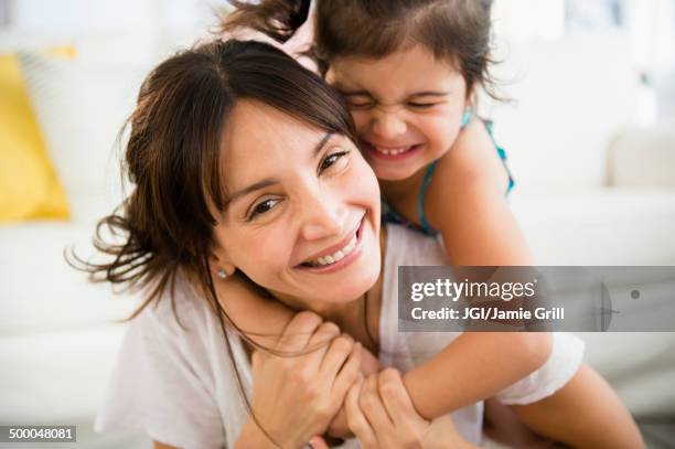 hispanic mother and daughter playing in living room - mother and child imagens e fotografias de stock