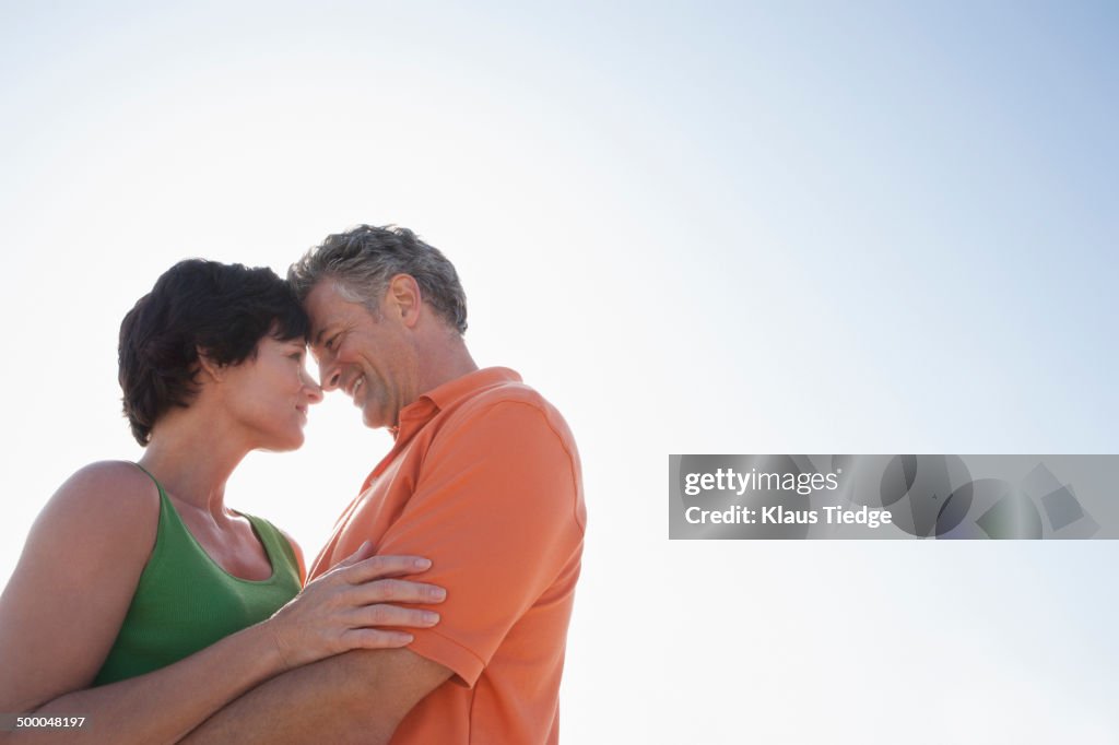 Caucasian couple hugging outdoors