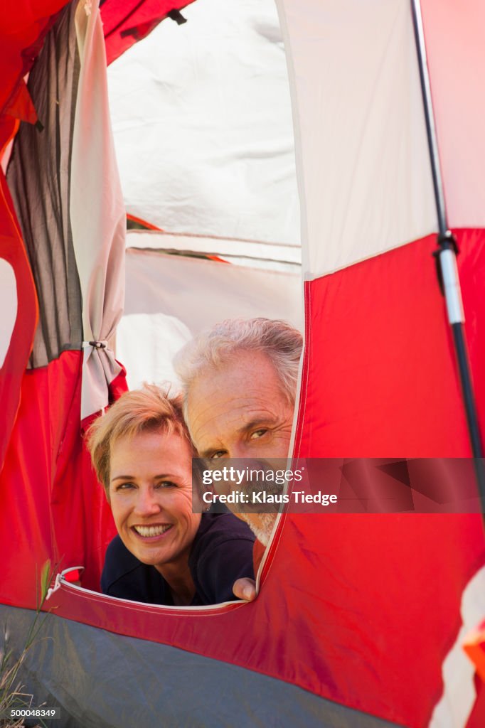Senior Caucasian couple relaxing in tent