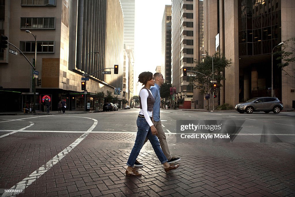 Couple crossing city street