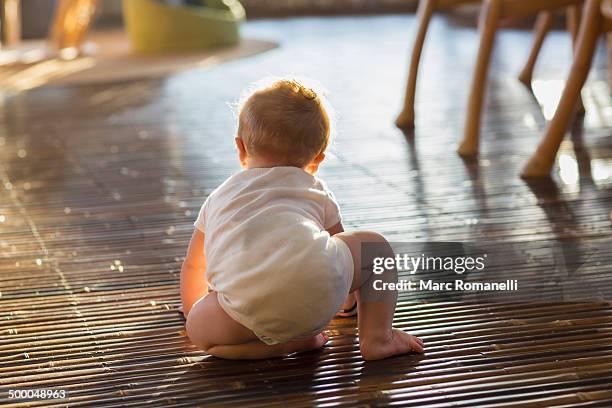 caucasian baby crawling on floor - baby first steps stock-fotos und bilder