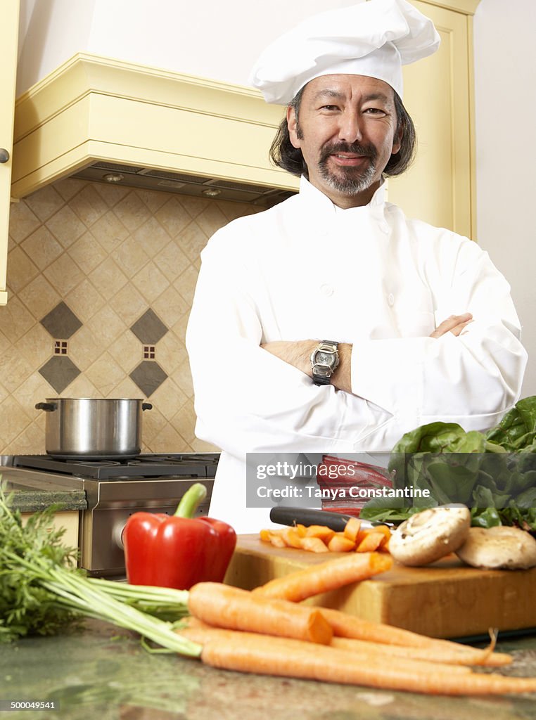 Mixed race chef working in kitchen