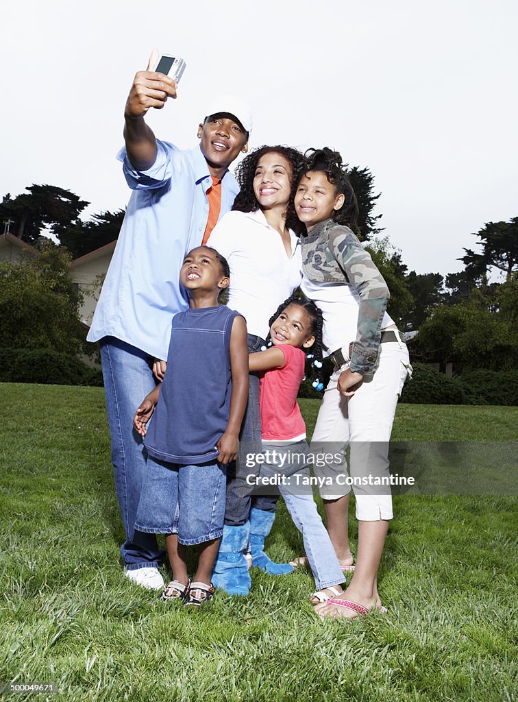Family taking picture together in park
