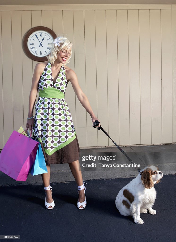 Caucasian woman with dog on sidewalk