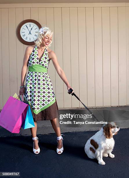 caucasian woman with dog on sidewalk - teimoso - fotografias e filmes do acervo