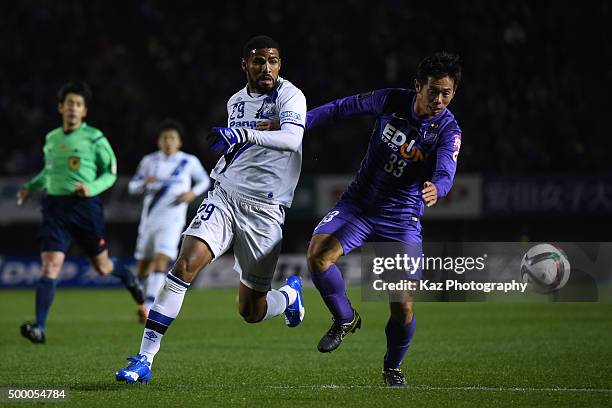 Tsukasa Shiotani of Sanfrecce Hiroshima keeps the ball under the pressure from Patric of Gamba Osaka during the J.League 2015 Championship final 2nd...