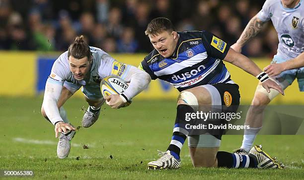 Ben Foden of Northampton dives past David Wilson during the Aviva Premiership match between Bath and Northampton Saints at the Recreation Ground on...