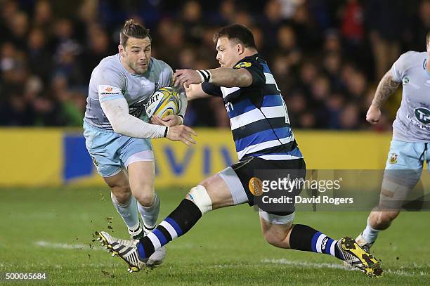 Ben Foden of Northampton dives past David Wilson during the Aviva Premiership match between Bath and Northampton Saints at the Recreation Ground on...