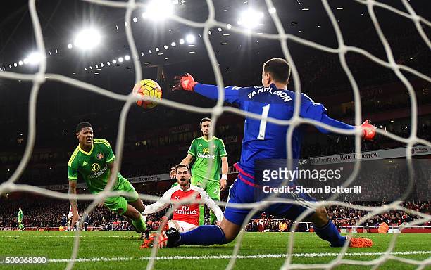 Aaron Ramsey of Arsenal scores his team's third goal past Costel Pantilimon of Sunderland during the Barclays Premier League match between Arsenal...