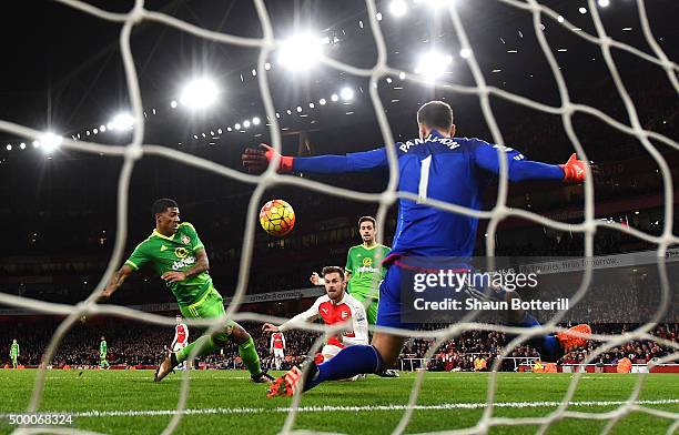 Aaron Ramsey of Arsenal scores his team's third goal past Costel Pantilimon of Sunderland during the Barclays Premier League match between Arsenal...