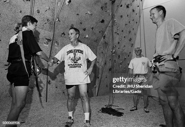 Michael Rubens Bloomberg, Candid shot, Bloomberg is standing in front of an indoor climbing wall with three instructors, Bloomberg is shaking hands...