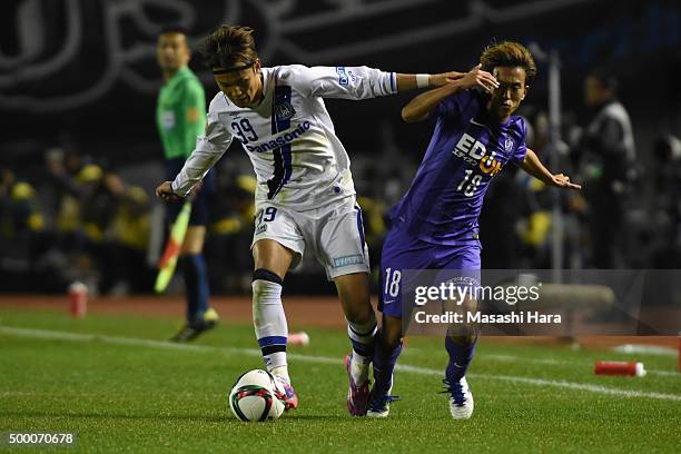 Takashi Usami of Gamba Osaka and Yoshifumi Kashiwa of Sanfrecce Hiroshima compete for the ball during the J.League 2015 Championship final 2nd leg...