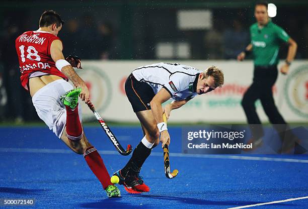 Paul Wharton of Canada vies with Niklas Wellen of Germany during the match between Germany and Canada on day nine of The Hero Hockey League World...