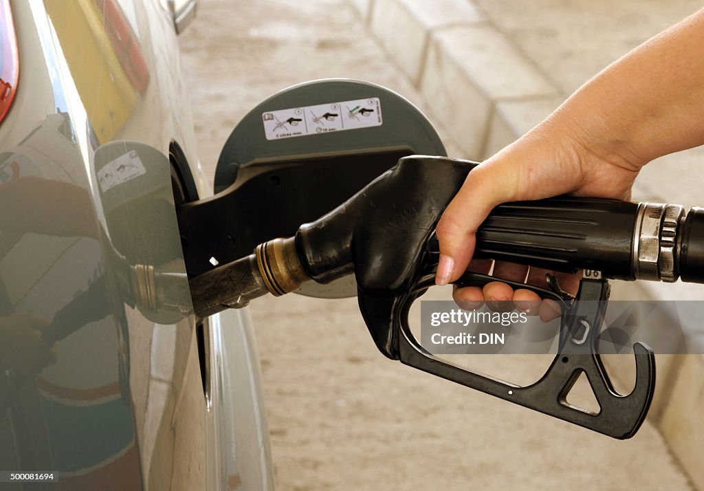 Putting gasoline in vehicle