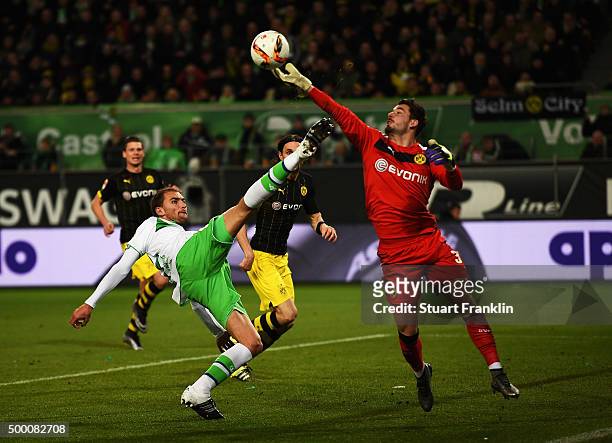 Roman Bürki of Dortmund saves a shot by Bas Dost of Wolfsburg during the Bundesliga match between VfL Wolfsburg and Borussia Dortmund at Volkswagen...
