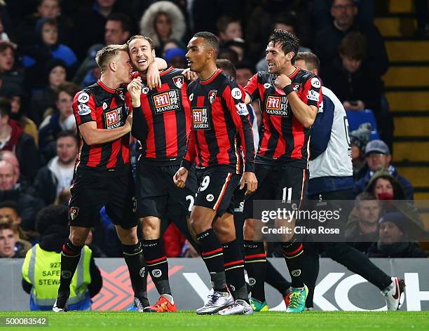 Glenn Murray of Bournemouth celebrates scoring his team's first goal with his team mates during the Barclays Premier League match between Chelsea and...