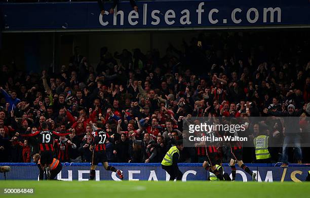 Glenn Murray of Bournemouth celebrates scoring his team's first goal with his team mates in front of their supporters during the Barclays Premier...