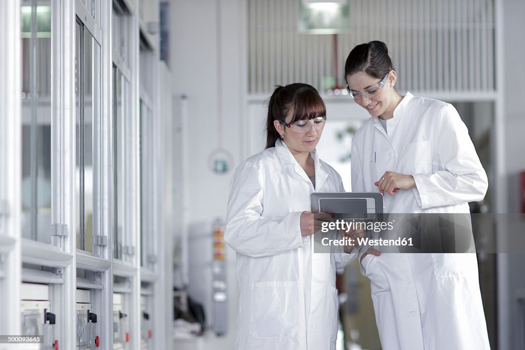 Two young female chemistry students in lab