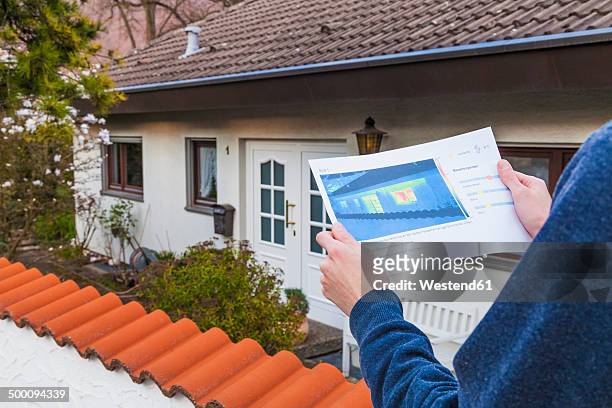 germany, geislingen, person holding thermography of building - thermal image stock-fotos und bilder