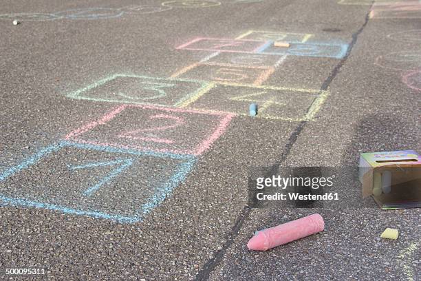 hopscotch drawing with coloured crayon on asphalt - hopscotch stock pictures, royalty-free photos & images