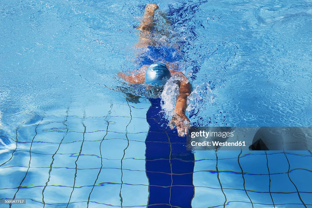 Female swimmer crawling in pool