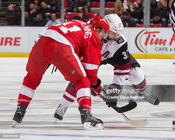 Luke Glendening of the Detroit Red Wings faces off against Dustin Jeffrey of the Arizona Coyotes during an NHL game at Joe Louis Arena on December 3,...