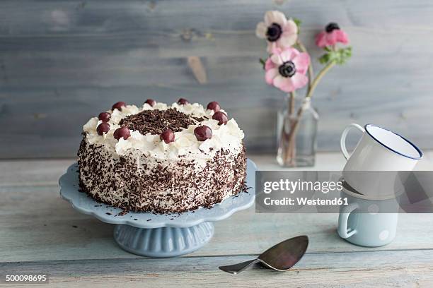 black forest cake on blue cake stand in front of grey background - cream cake stock pictures, royalty-free photos & images