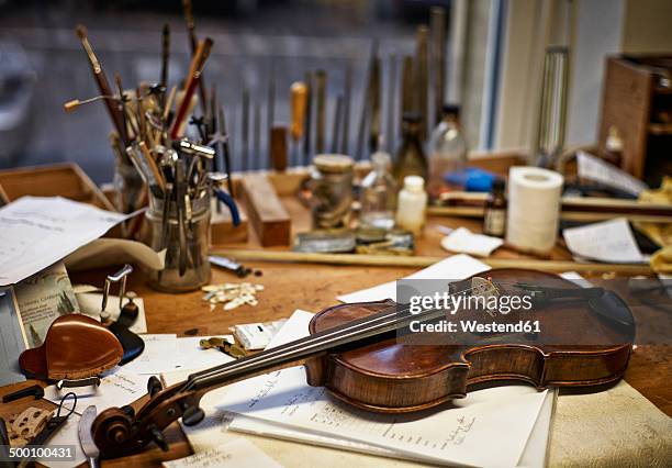 tools and damaged instruments in a violin maker's workshop - musical instrument repair stock pictures, royalty-free photos & images