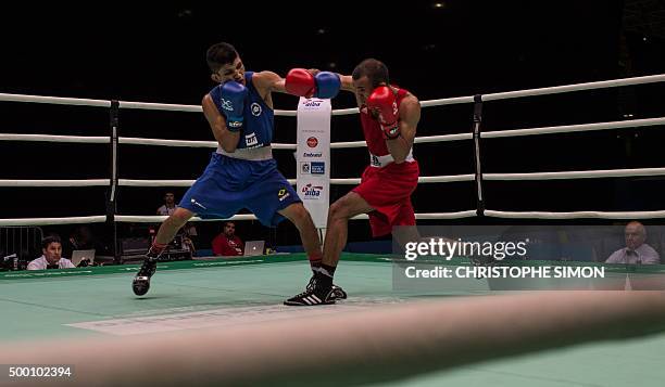 Brazilian Juliao De Miranda Henriques Neto fights against Marocan Achraf Kharroubi during the men's Fly test event for Rio 2016 Olympic Games, in Rio...
