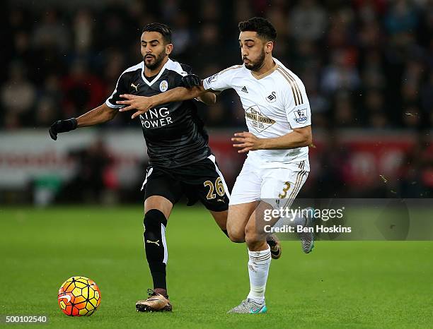 Neil Taylor of Swansea holds off pressure from Riyad Mahrez of Leicester during the Barclays Premier League match between Swansea City and Leicester...