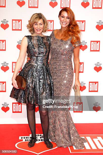 Gesine Cukrowski and Yasmina Filali attend the Ein Herz Fuer Kinder Gala 2015 at Tempelhof Airport on December 5, 2015 in Berlin, Germany.