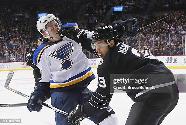 Travis Hamonic of the New York Islanders hits Vladimir Tarasenko of the St. Louis Blues at the Barclays Center on December 4, 2015 in Brooklyn...