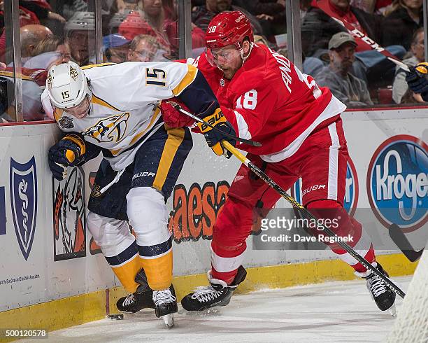 Joakim Andersson of the Detroit Red Wings battles for the puck with Craig Smith of the Nashville Predators during an NHL game at Joe Louis Arena on...