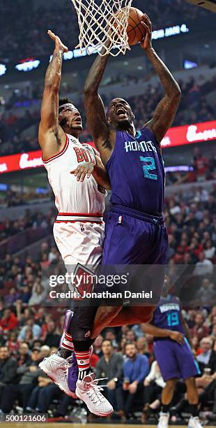 Marvin Williams of the Charlotte Hornets gets off a shot under pressure from Derrick Rose of the Chicago Bulls at the United Center on December 5,...