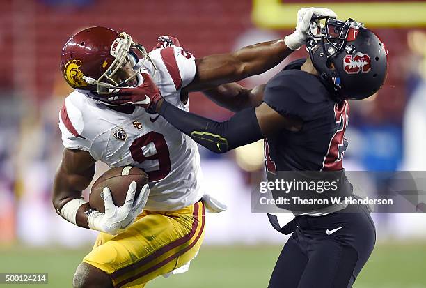 JuJu Smith-Schuster of the USC Trojans stiff arms Ronnie Harris of the Stanford Cardinal during the second quarter of the NCAA Pac-12 Championship...