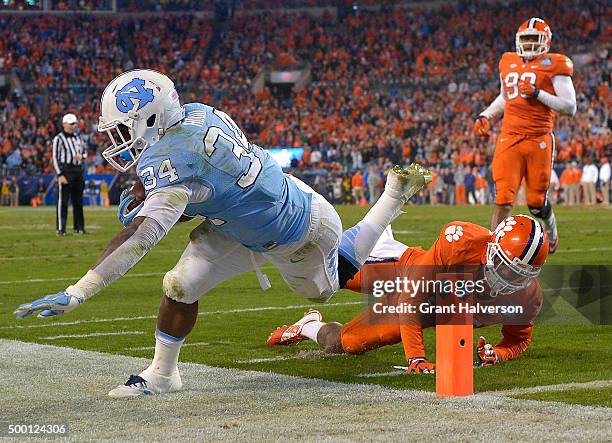 Cordrea Tankersley of the Clemson Tigers knocks Elijah Hood of the North Carolina Tar Heels out-of-bounds just short of the goal line during the...