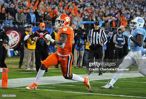 Clemson running back Wayne Gallman, left, reaches the end zone with a 16-yard touchdown reception as North Carolina linebacker Shakeel Rashad, right,...