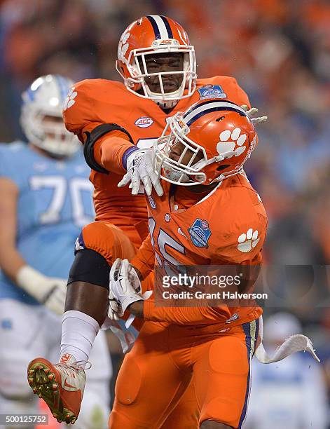 Shaq Lawson and T.J. Green of the Clemson Tigers celebrate after sacking Marquise Williams of the North Carolina Tar Heels during the Atlantic Coast...