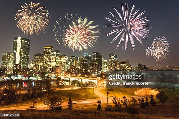 skyline of  calgary with fireworks for the new year - calgary summer stock pictures, royalty-free photos & images