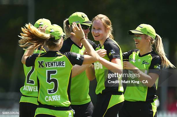 Lauren Cheatle of the Thunder celebrates with team mates after taking the wicket of Sara McGlashan of the Sixers during the Women's Big Bash League...