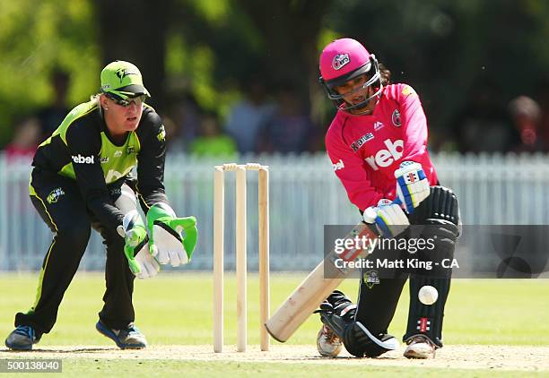 Lisa Sthalekar of the Sixers bats as Claire Koski of the Thunder keeps wicket during the Women's Big Bash League match between the Sydney Thunder and...